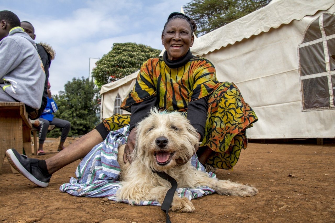 Two children holding small puppy - World Animal Protection